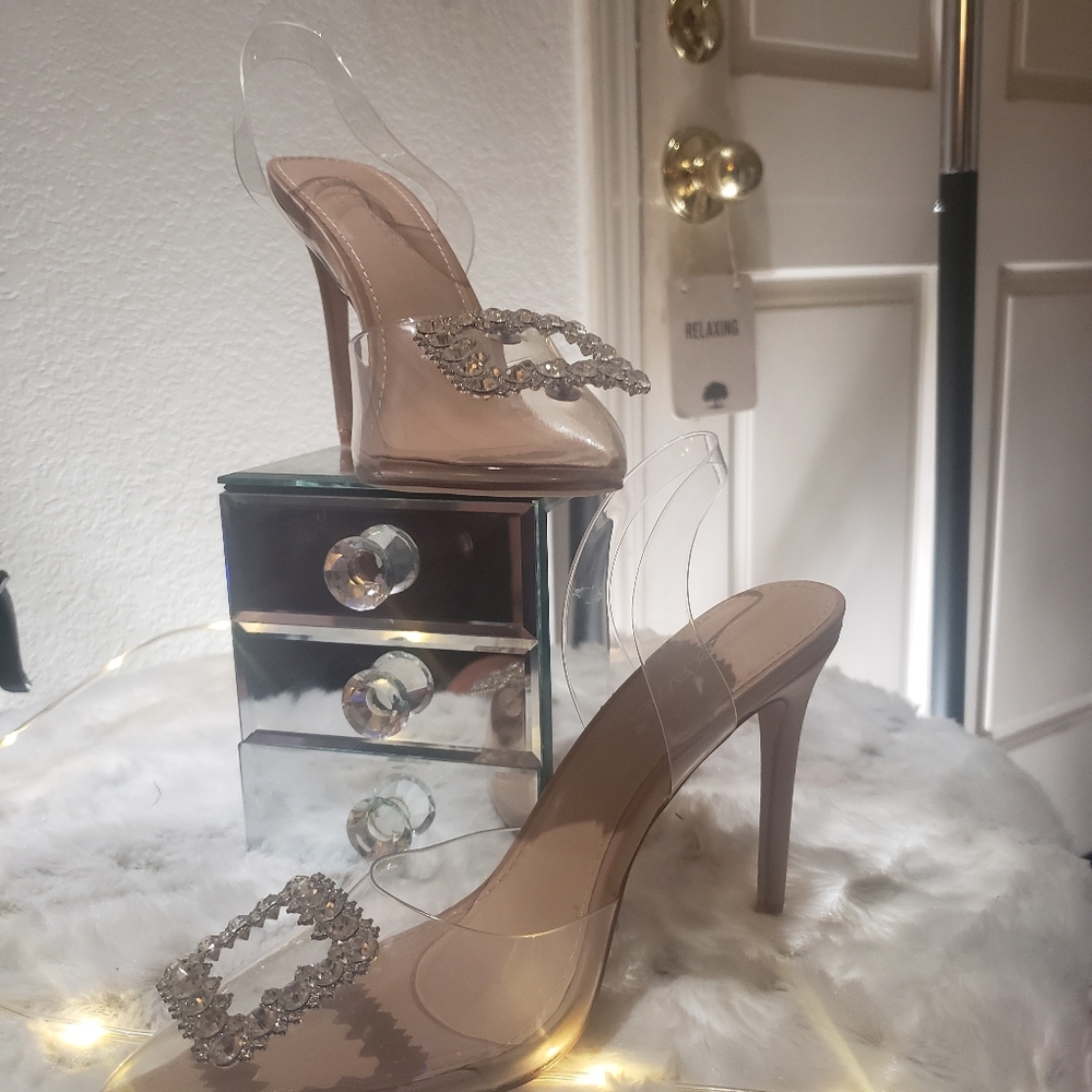 Clear slingback pumps with a rhinestone buckle.and beige 3 1/2 in. Stiletto heel